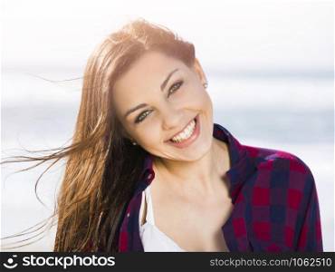 Portrtait of a happy girl at the beach smilling
