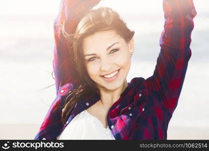 Portrtait of a happy girl at the beach smilling