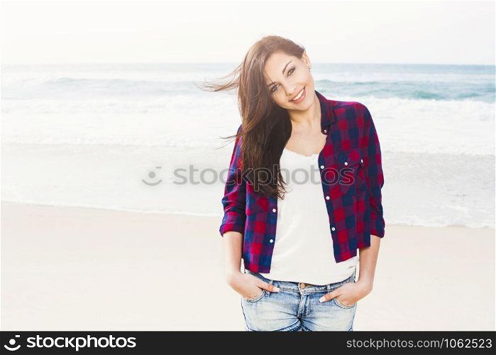 Portrtait of a happy girl enjoying the day on the beach