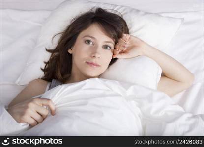 Porttrait of a beautiful and natural young girl on the bed