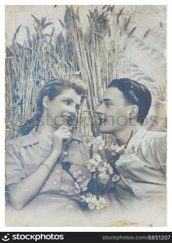 PORTUGAL, LISBON - CIRCA 1950 : old photo of happy young romantic couple of woman and man in summer harvesting field. Illustrative Image, subject of human interest.