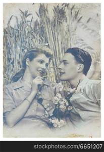 PORTUGAL, LISBON - CIRCA 1950 : old photo of happy young romantic couple of woman and man in summer harvesting field. Illustrative Image, subject of human interest.