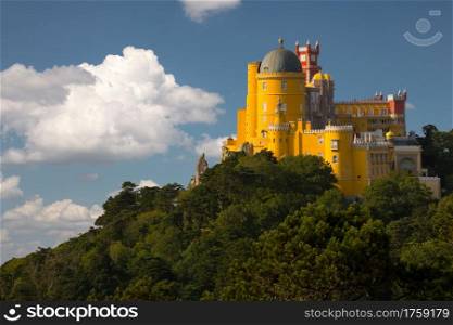 Portugal. Sintra. The Pena Palace on a cliff surrounded by forest and clouds. Portugal. Pena Palace in Sintra