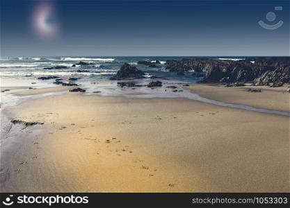 Portuguese Atlantic Ocean beach in the light of the moon. Breathtaking landscape and nature of the Portugal, popular travel destination in western Europe.