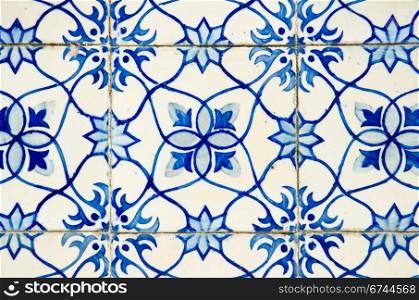 Portuguese azulejos, old tiled blue background.