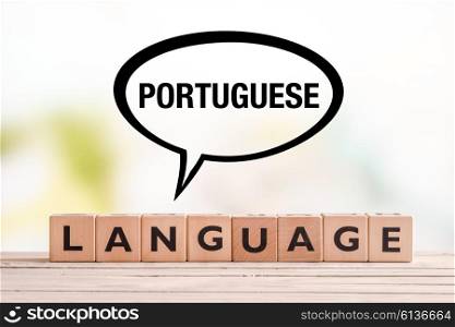 Portuguese language lesson sign made of cubes on a table