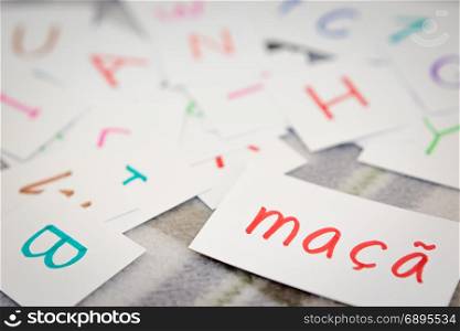 Portuguese; Learning the New Word with the Alphabet Cards; Writing APPLE
