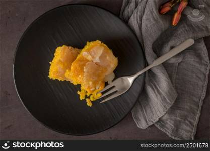 Portuguese sponge cake bolinhol from Vizela, served on a plate. On kitchen countertop.
