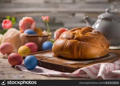 Portuguese traditional Easter cake. Folar with eggs on wooden table