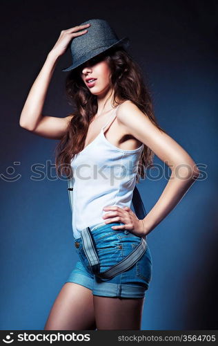 posing sexy woman in hat and shorts with suspenders