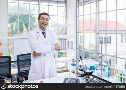 Positive and joyful funny crazy joke emotions Confident scientist portrait of Happy male scientist keeping arms crossed in chemistry lab scientist holding test tube with sample in Laboratory analysis