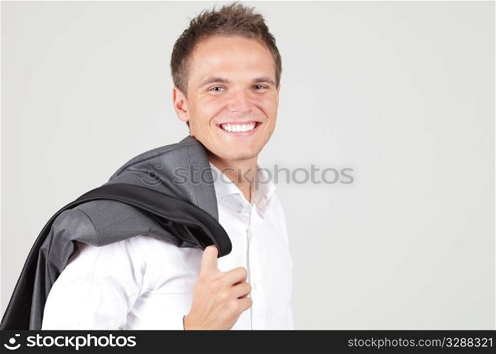 Positive businessman having a pause with jacket off over white background