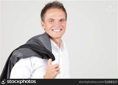 Positive businessman having a pause with jacket off over white background