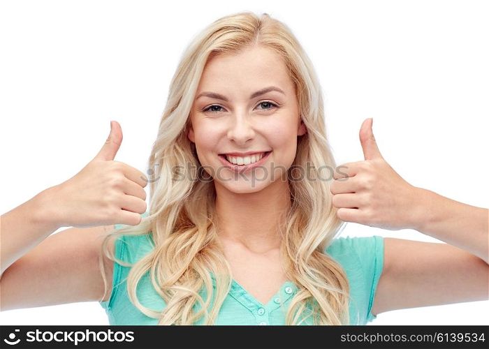 positive gesture and people concept - smiling young woman or teenage girl showing thumbs up with both hands. happy woman or teenage girl showing thumbs up
