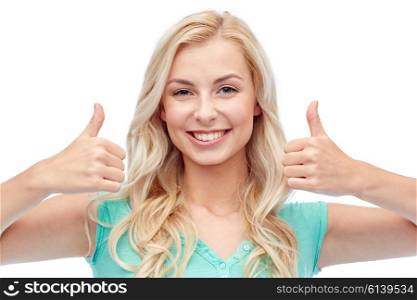 positive gesture and people concept - smiling young woman or teenage girl showing thumbs up with both hands. happy woman or teenage girl showing thumbs up