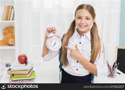 positive schoolgirl pointing clock