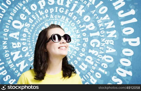 Positive teenager. Young girl teenager in sunglasses and yellow shirt