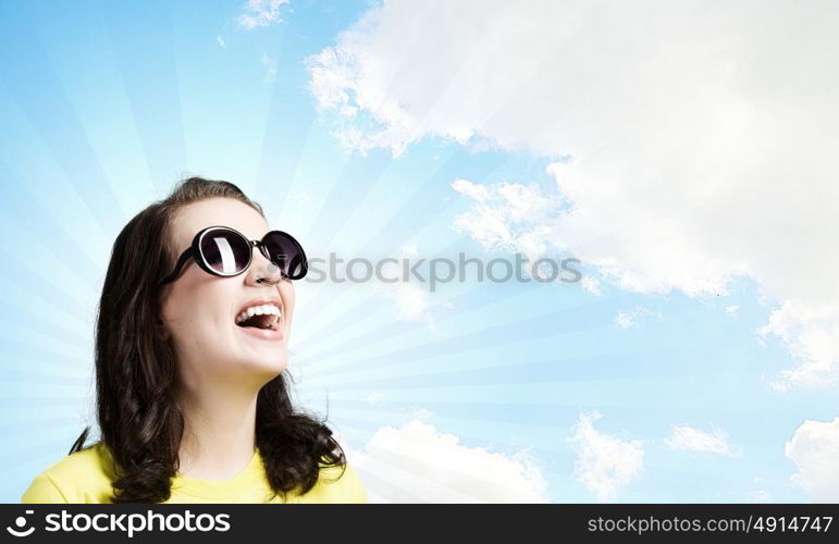 Positive teenager. Young girl teenager in sunglasses and yellow shirt