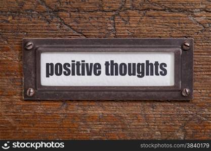 positive thoughts - file cabinet label, bronze holder against grunge and scratched wood