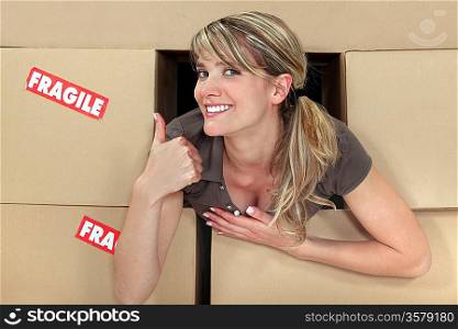 Positive woman with packing boxes