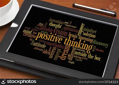positve thinking concept - word cloud on a digital tablet with a cup of tea