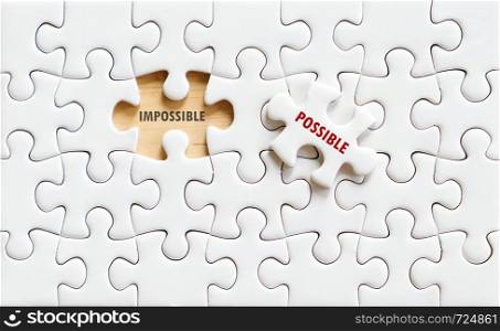 Possible and impossible words on jigsaw puzzle background, business concept, positive thinking, quotation