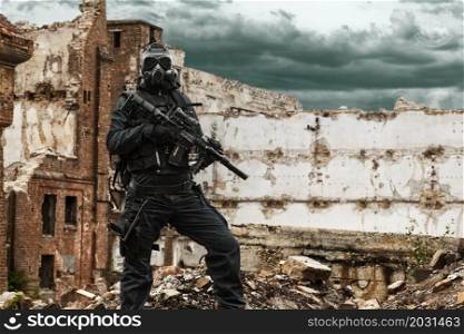 Post apocalypse. Sole survivor in tatters and gas mask on the ruins of the destroyed city. Nuclear post apocalypse survivor