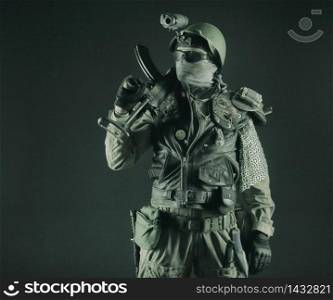 Post apocalyptic world bandit or marauder, nuclear disaster survivor, veteran stalker in face mask and sunglasses, handicraft lamellar armor, armed with handmade pistol, isolated on black studio shoot. Post apocalyptic survivor with handmade pistol