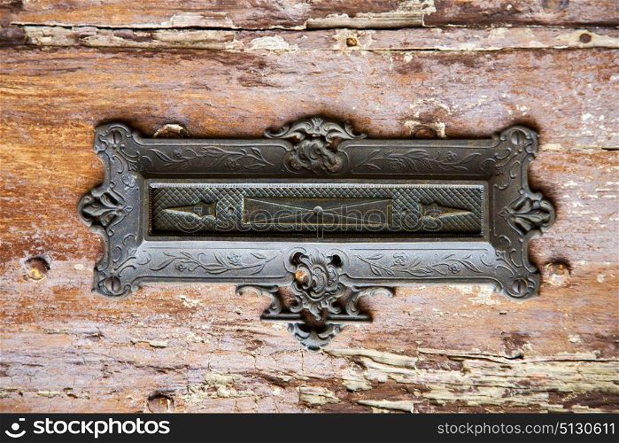 post mail abstract rusty brass brown knocker in a door curch closed wood lombardy italy varese azzate