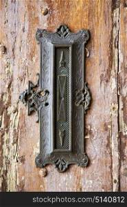 post mail abstract rusty brass brown knocker in a door curch closed wood lombardy italy varese azzate