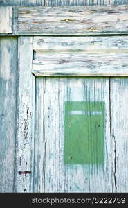 post mail castronno abstract rusty brass brown knocker in a door curch closed wood lombardy italy varese