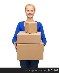 post, package and delivery concept - smiling woman in casual clothes with many parcel boxes