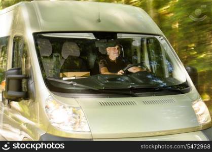Postal delivery courier man driving cargo van delivering package