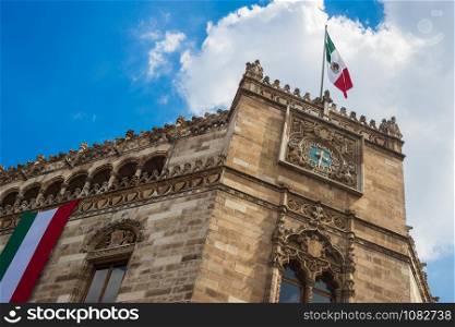 Postal palace building with mexican flag in mexico city downtown.