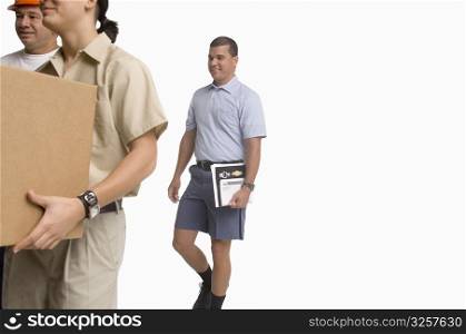 Postal worker, delivery man and construction worker walking