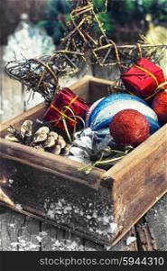 Postcard with Christmas. Stylish wooden box with Christmas decorations and pine cones