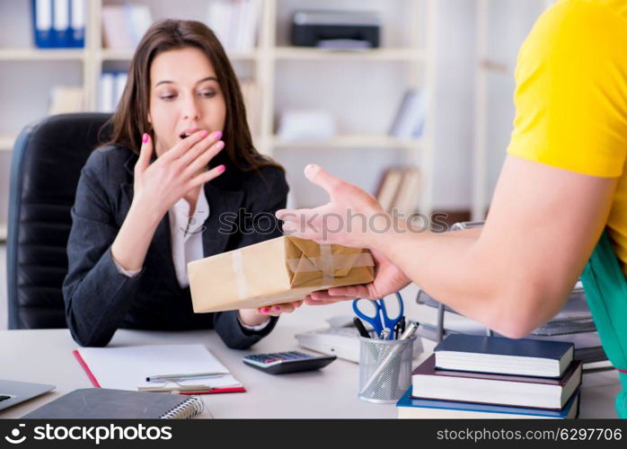 Postman delivering parcel to the office