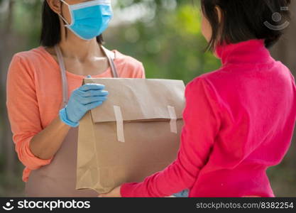 postman, delivery man wearing mask carry small box deliver to customer in front of door at home. woman wearing mask prevent covid 19, coronavirus infection outbreak. home delivery shopping concept.