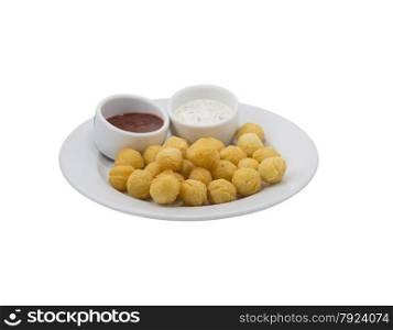 Potato balls with sauce on a dish with isolated background. Potato balls with sauce