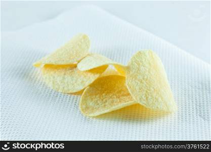 potato chips on tissue in white isolated.white background studio packshot.