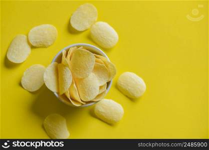 Potato chips snack on bowl and yellow background, Crispy potato
