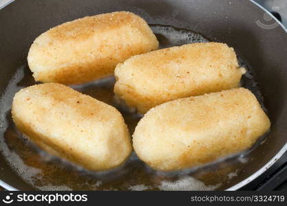 potato croquettes cooked on a frying pan