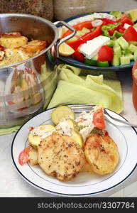 Potato dish and Greek salad