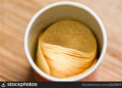 Potato hips on cans paper, Stacked potato chips is snack in package ready to eat and fat food or junk food