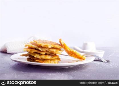 Potato pancakes, fried vegetable pancakes on plate. Potato pancakes on white plate on a table