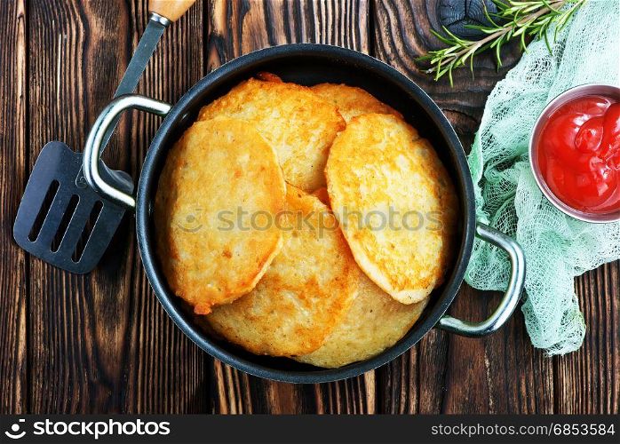 potato pancakes in pan and on a table