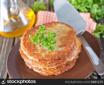 potato pancakes on plate and on a table