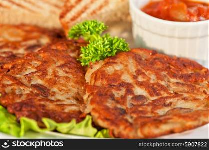 potato pancakes. potato pancakes with toast bread and jam closeup