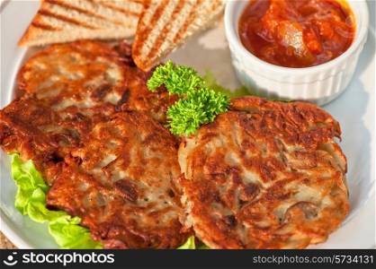 potato pancakes with toast bread and jam closeup