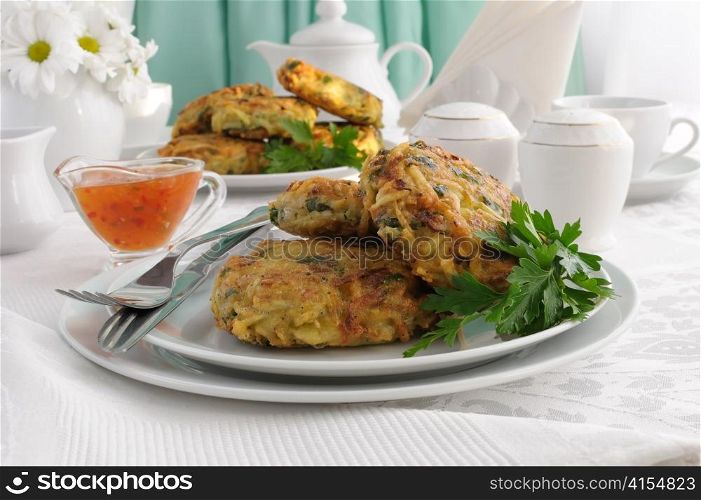 Potato pancakes with vegetables, sauce on the plate